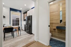 Wallpaper ideas for a tiny powder room with a bold blue geometric floor?