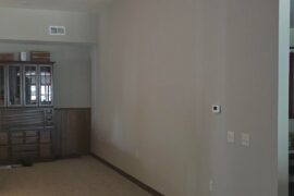 Could I please get help decorating this very large wall in our living area?